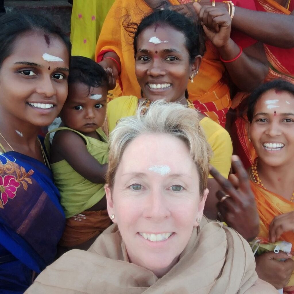 Lynn Jarman - Writer Travelling Planet Earth Travelling in India posing for photograph with locals