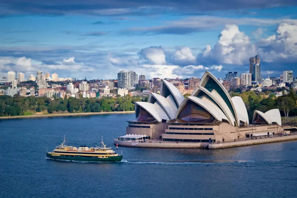 Explore Sydney in Style - Image of Sydney Opera House with Manly ferry on Sydney Harbour